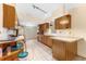 Kitchen with tiled floors, abundant counter space and wooden cabinetry at 1609 S Valrico Rd, Valrico, FL 33594