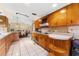 Kitchen featuring wood cabinets, tile flooring, and an open layout at 1609 S Valrico Rd, Valrico, FL 33594