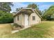 Side view of outbuilding showing a single entry door and simple architectural details at 1609 S Valrico Rd, Valrico, FL 33594