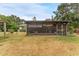 View of the screened-in back patio with a glimpse of the outdoor scenery and surrounding landscape at 1609 S Valrico Rd, Valrico, FL 33594