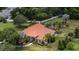 Expansive aerial view of a secluded residence featuring a clay tile roof and mature landscaping at 16124 Suncrest Shores Dr, Odessa, FL 33556