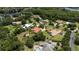 An aerial view of the neighborhood showcasing lush trees, lake, and a variety of single Gathering homes at 16124 Suncrest Shores Dr, Odessa, FL 33556
