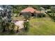 This home has a spacious backyard with a fire pit, palm trees, and a screened in lanai with a pool at 16124 Suncrest Shores Dr, Odessa, FL 33556