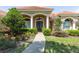 Beautiful home with a tile roof, well-manicured landscaping, and elegant entrance at 16124 Suncrest Shores Dr, Odessa, FL 33556