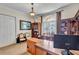 Home office with built-in bookshelves, a large window, and a work area at 16124 Suncrest Shores Dr, Odessa, FL 33556