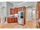 This spacious kitchen features wood cabinets, stainless steel appliances, and tiled floors at 16124 Suncrest Shores Dr, Odessa, FL 33556