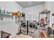 Efficient laundry room with modern washer, dryer, shelving and a countertop at 16124 Suncrest Shores Dr, Odessa, FL 33556
