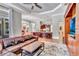 Living room area features large leather sofa, view of kitchen, and a custom entertainment center at 16124 Suncrest Shores Dr, Odessa, FL 33556