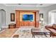 Living room features a custom entertainment center and a view of the outdoor living area at 16124 Suncrest Shores Dr, Odessa, FL 33556