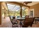 Outdoor patio with seating area overlooking the pool and landscaped backyard at 16124 Suncrest Shores Dr, Odessa, FL 33556