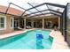 Inviting pool surrounded by an outdoor entertainment area and tile roof at 16124 Suncrest Shores Dr, Odessa, FL 33556