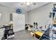 Versatile room with flexible storage system, exercise equipment, and gray flooring at 16124 Suncrest Shores Dr, Odessa, FL 33556
