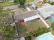 An aerial shot captures a single-Gathering home, featuring a spacious backyard, a shed, and a private pool nearby at 1624 Chateau Dr, Clearwater, FL 33756