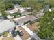 An aerial view showcases a charming single-Gathering home with a well-manicured lawn, a concrete driveway and lush landscaping at 1624 Chateau Dr, Clearwater, FL 33756