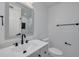 Clean and modern bathroom with white fixtures and black accents at 1624 Chateau Dr, Clearwater, FL 33756