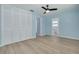 Light blue bedroom features wood floors, ceiling fan, and closet at 1624 Chateau Dr, Clearwater, FL 33756