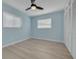 Bedroom with hardwood floors, two windows, and a ceiling fan at 1624 Chateau Dr, Clearwater, FL 33756