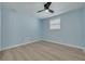 Light blue bedroom with wood floors, ceiling fan, and a window at 1624 Chateau Dr, Clearwater, FL 33756