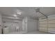 A clean, well-lit garage with ample storage space, including shelves and a sink, perfect for projects or parking at 1624 Chateau Dr, Clearwater, FL 33756