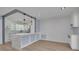 Open concept kitchen with a large marble island, pendant lighting, and white cabinetry at 1624 Chateau Dr, Clearwater, FL 33756