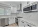 Bright kitchen with stainless steel appliances, marble countertops and white cabinetry at 1624 Chateau Dr, Clearwater, FL 33756