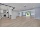 Open-concept living room featuring hardwood floors, and recessed lights, seamlessly flowing into kitchen at 1624 Chateau Dr, Clearwater, FL 33756