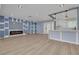 Bright open living room featuring wood floors, fireplace, and stylish lighting fixtures at 1624 Chateau Dr, Clearwater, FL 33756