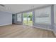 Bright living room with sliding glass doors to the backyard, and hardwood floors at 1624 Chateau Dr, Clearwater, FL 33756