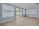 Bright living room with sliding glass doors to the backyard, and hardwood floors at 1624 Chateau Dr, Clearwater, FL 33756