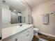 Well-lit bathroom with a white vanity, framed mirror, and modern fixtures at 18001 Richmond Place Dr # 330, Tampa, FL 33647