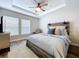 Serene bedroom showcasing a decorative headboard, soft gray linens, and tray ceiling at 18001 Richmond Place Dr # 330, Tampa, FL 33647
