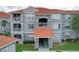 Exterior elevation of the apartment building showcasing the architecture and well-maintained landscaping at 18001 Richmond Place Dr # 330, Tampa, FL 33647