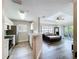 Open living area featuring modern gray floors, neutral walls, and light-filled balcony access at 18001 Richmond Place Dr # 330, Tampa, FL 33647