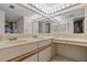 Bathroom featuring dual sinks with a vanity, mirrors, and great lighting at 18400 Gulf Blvd # 1105, Indian Shores, FL 33785