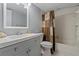 Bathroom with modern vanity, sink, toilet, and bathtub with shower at 18400 Gulf Blvd # 1105, Indian Shores, FL 33785