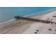 Scenic beach view featuring a wooden fishing pier extending into the ocean at 18400 Gulf Blvd # 1105, Indian Shores, FL 33785