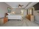 Bright bedroom with soft carpet, ocean-themed artwork, and a bathroom view at 18400 Gulf Blvd # 1105, Indian Shores, FL 33785