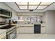 Well-lit kitchen featuring stainless steel appliances and updated white cabinets at 18400 Gulf Blvd # 1105, Indian Shores, FL 33785