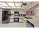 Functional kitchen with stainless steel appliances, white countertops, and ample cabinet space at 18400 Gulf Blvd # 1105, Indian Shores, FL 33785