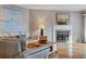 Cozy living room features a fireplace, hardwood floors, and comfortable leather seating at 18400 Gulf Blvd # 1105, Indian Shores, FL 33785