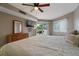Bright bedroom with ceiling fan, television, and sliding glass doors to a balcony at 18400 Gulf Blvd # 1105, Indian Shores, FL 33785