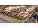 Aerial view of shopping center with wide parking and retail stores at 18400 Gulf Blvd # 1105, Indian Shores, FL 33785