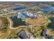 Aerial view of the resort-style community amenities, including pools, lakes, and sports courts at 18933 Sailors Delight Pass, Land O Lakes, FL 34638