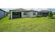 Lush backyard with green lawn and screened-in porch, ideal for outdoor activities at 18933 Sailors Delight Pass, Land O Lakes, FL 34638