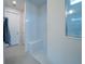 Bright bathroom with a tiled shower, a built-in bench, and neutral tile flooring at 18933 Sailors Delight Pass, Land O Lakes, FL 34638