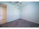Clean bedroom with carpeted floors, a ceiling fan, and a closet with bi-fold doors at 18933 Sailors Delight Pass, Land O Lakes, FL 34638