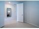 Neutral-toned bedroom with tile flooring and doorway to the mirror-decorated hallway at 18933 Sailors Delight Pass, Land O Lakes, FL 34638