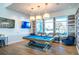 Well-appointed billiards room with a blue pool table, comfortable seating, and a relaxing ambiance at 18933 Sailors Delight Pass, Land O Lakes, FL 34638