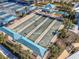 Aerial view of bocce ball court, featuring covered seating and manicured landscaping at 18933 Sailors Delight Pass, Land O Lakes, FL 34638