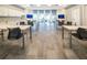 Well-lit common room with multiple tables, chairs, and kitchen space; ideal for work or events at 18933 Sailors Delight Pass, Land O Lakes, FL 34638